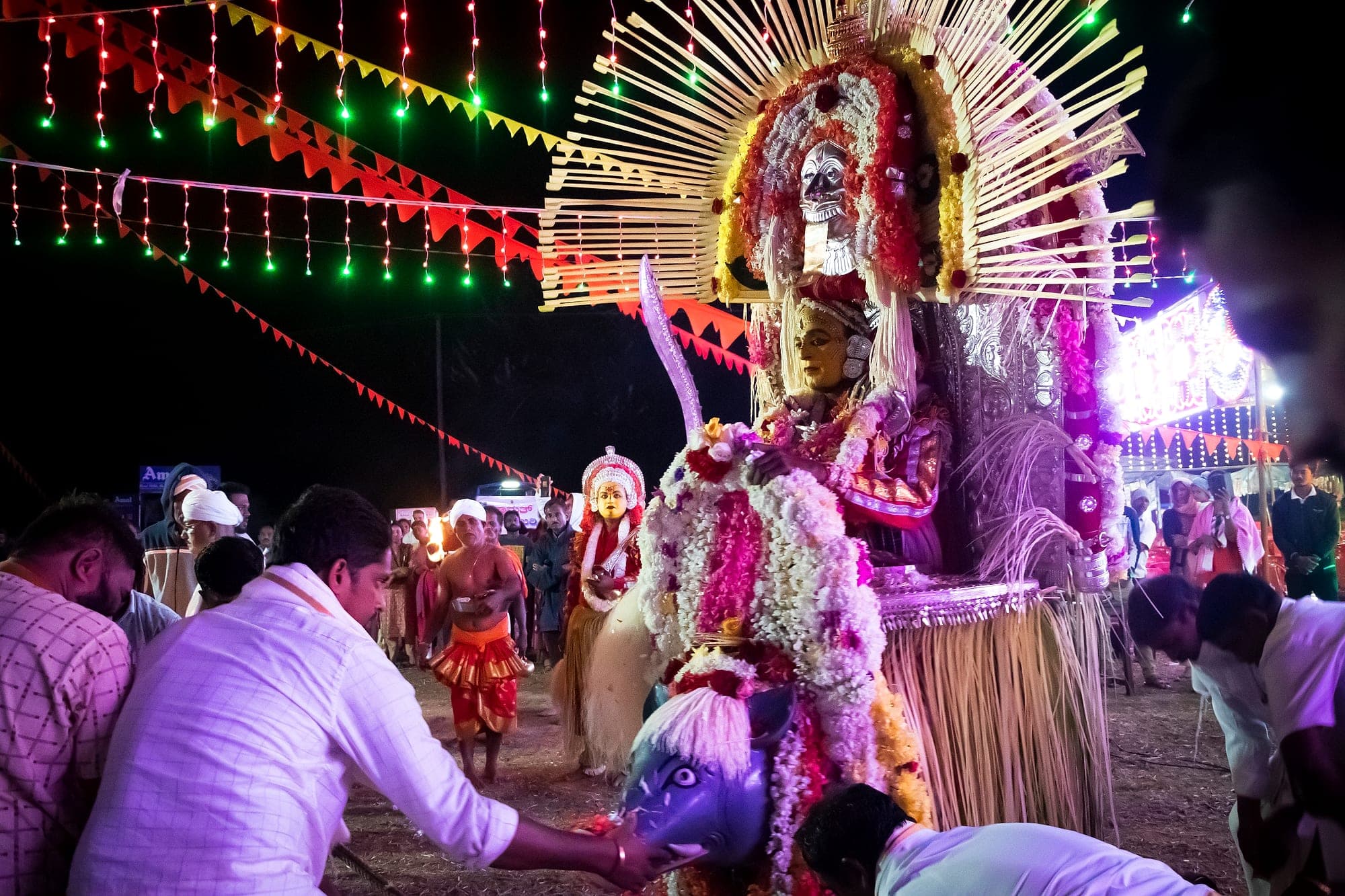 A Bhoota Kola performer in costume during a night ritual in coastal Karnataka