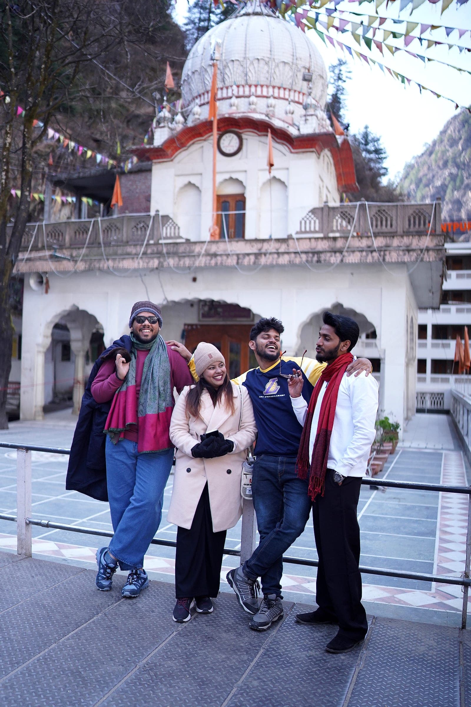 Four friends posing together outside the gurudwara at Manikaran