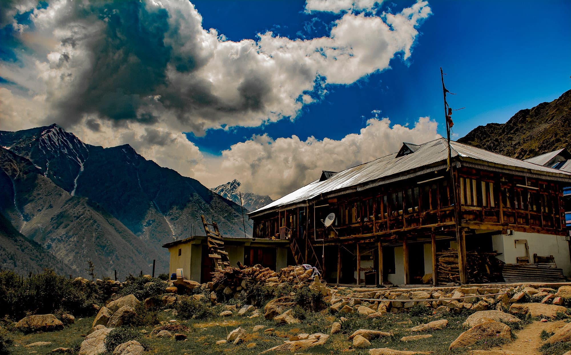 Traditional wooden houses at Chitkul with the Kinnaur mountains behind