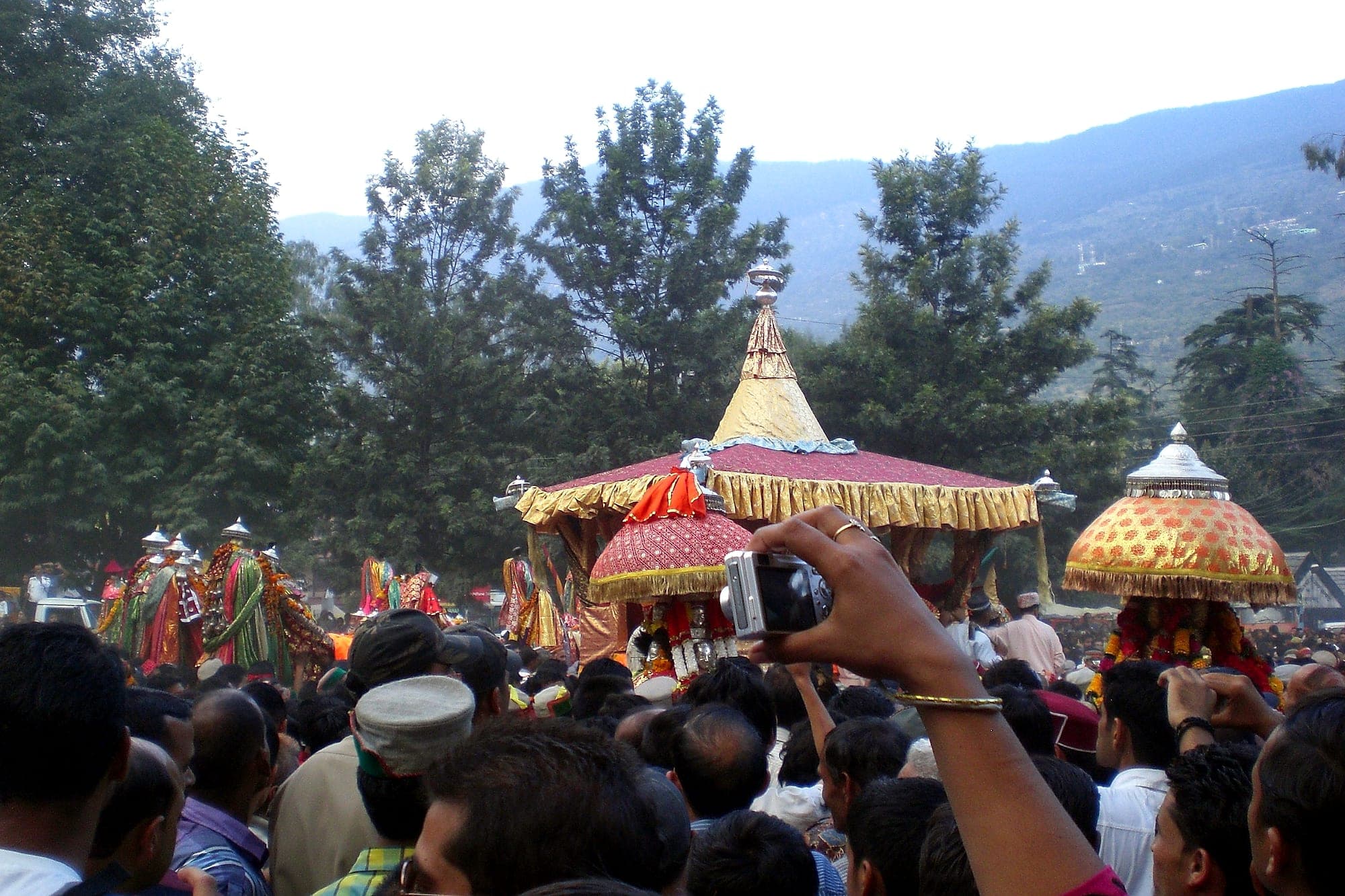 Village deities carried in palanquins through the crowd at Kullu Dussehra