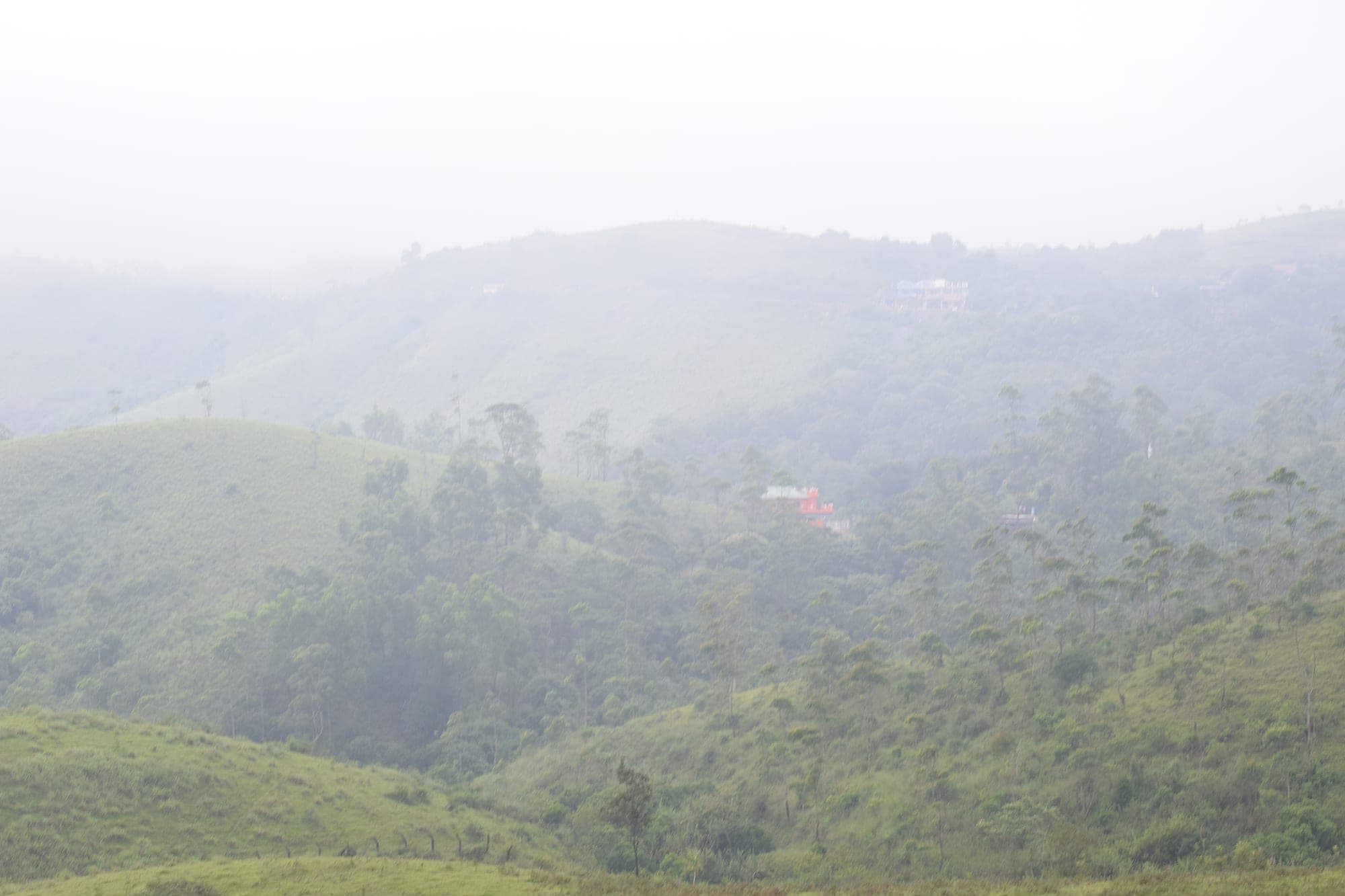 Mist rolling over the green hills at Vagamon, Kerala