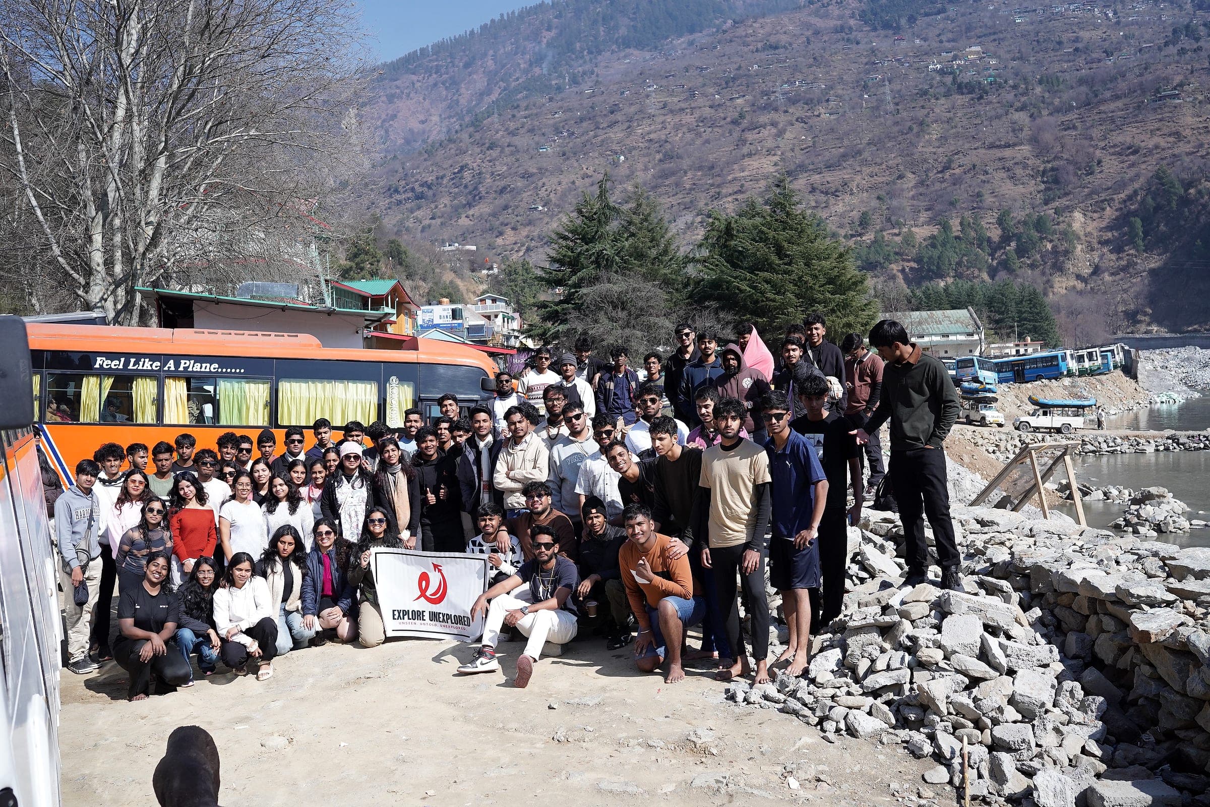 A college batch gathered with an Explore Unexplored banner in Himachal