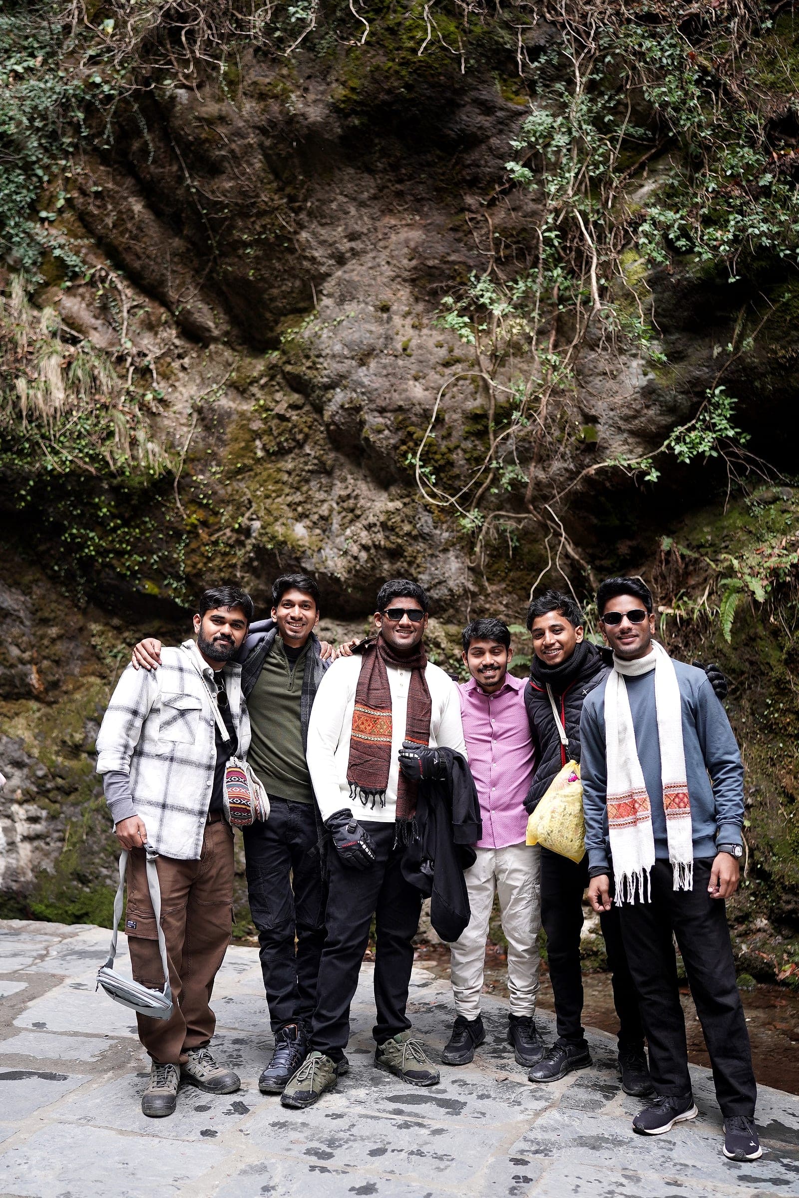 A smaller group posing on a rock face in Himachal