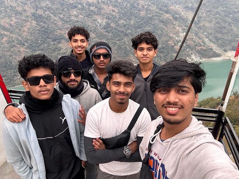 A group selfie on a bridge above the river at Rishikesh